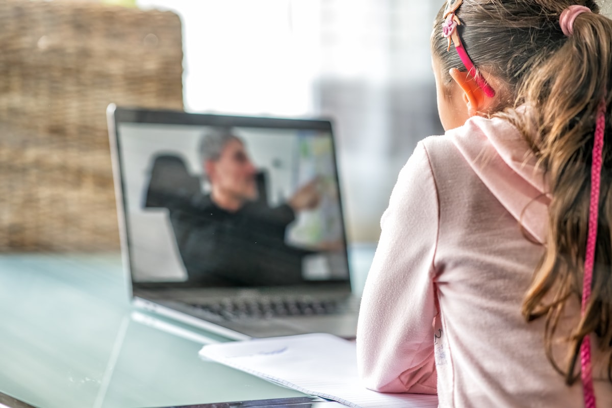 A teacher guiding a student during an online lesson