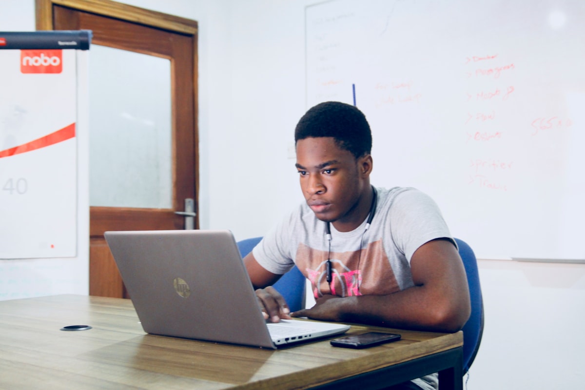A teacher planning a lesson on a laptop